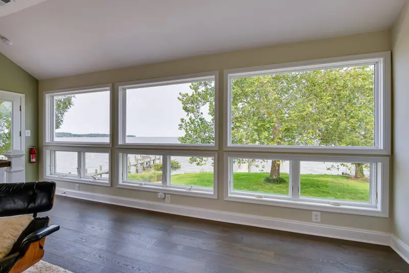 Wall of windows looking out over the lawn to the bay